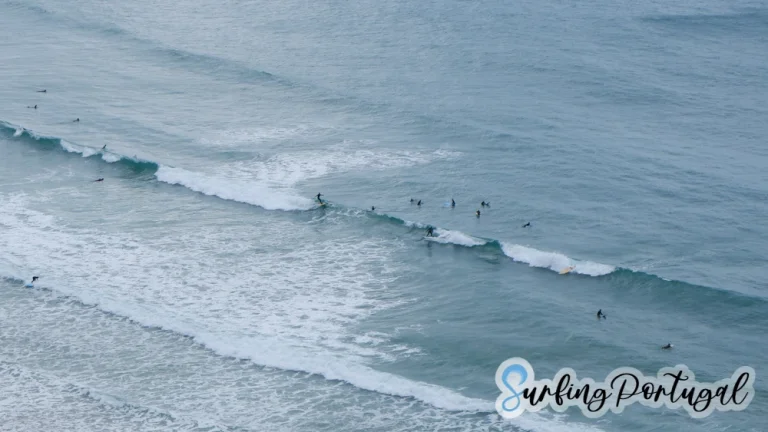 Surfers paddling for waves at Arrifana bay