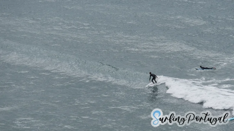 Surfer surfing a small wave in Arrifana