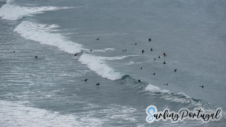 Pack of surfers in the water at Arrifana