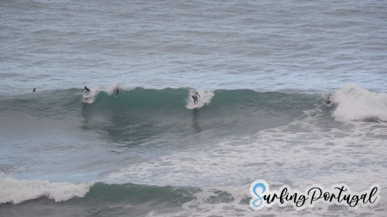 Two surfers on a wave at Praia do Sul, Ericeira