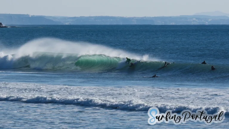 Two surfers paddling for a wave at Supertubos