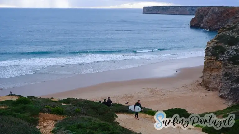 Surfer coming up the cliff after a surf at Beliche